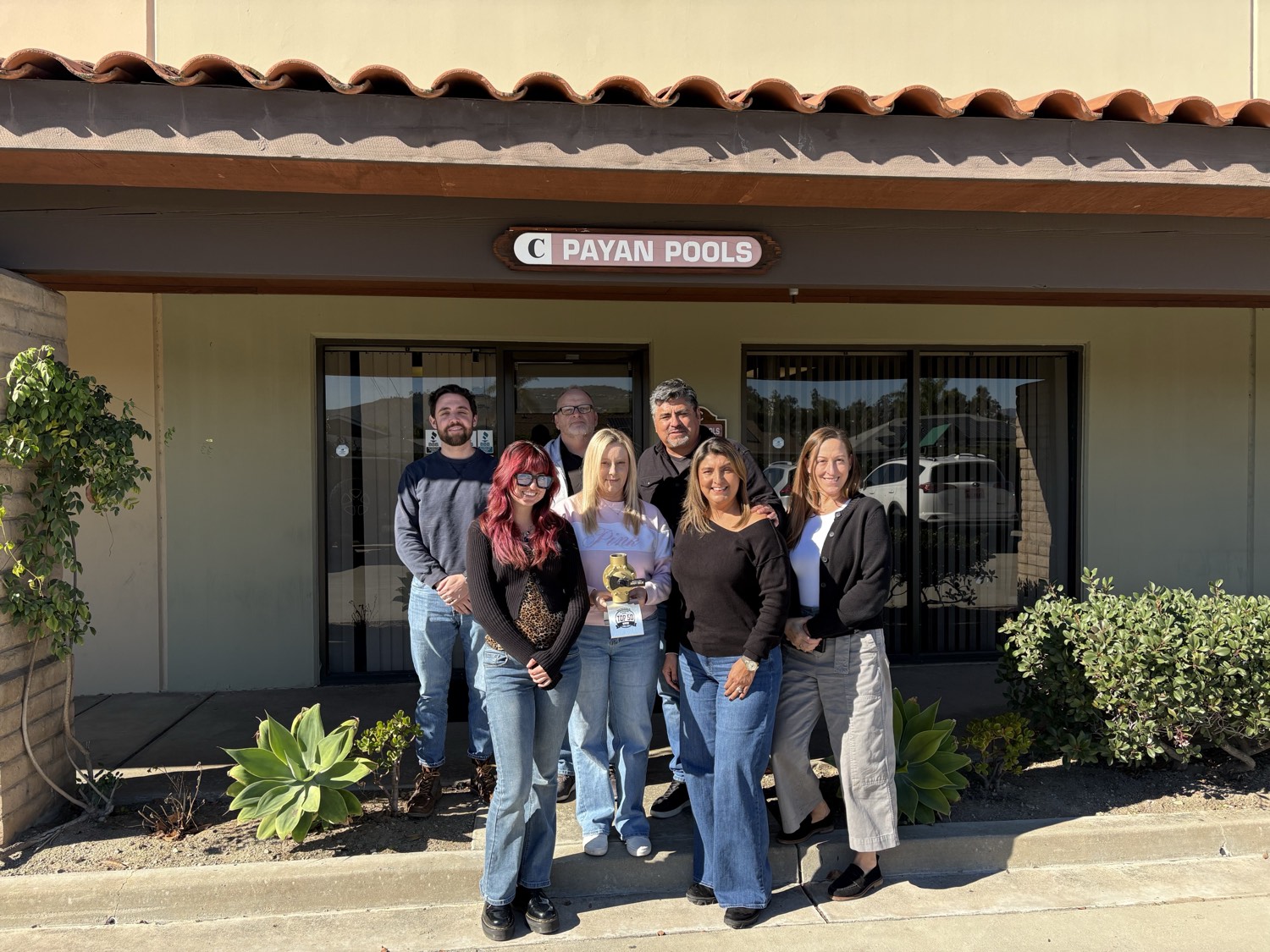 The Payan Pools team outside their San Diego office with a Top 50 Service award